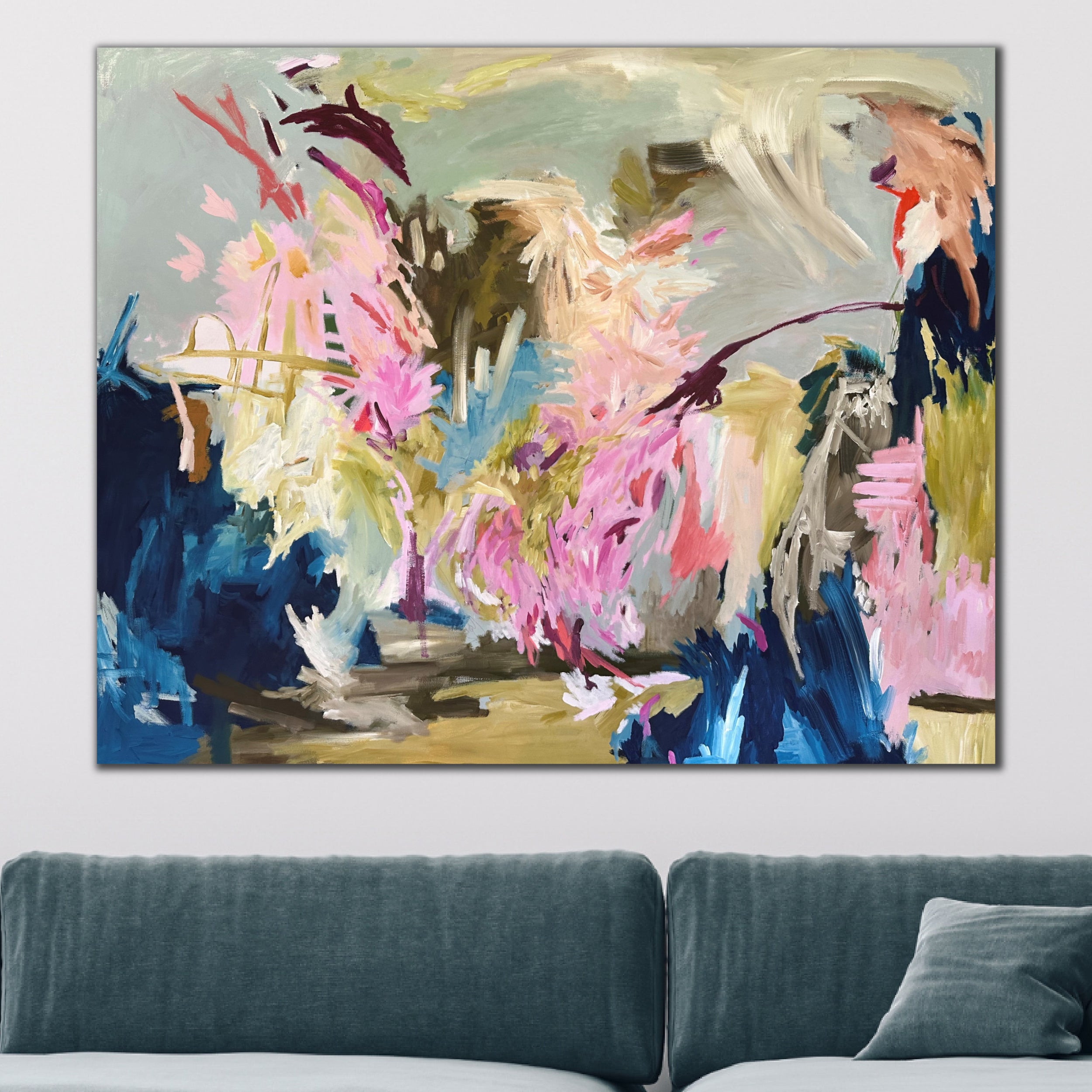 Colourful, large abstract painting with expressive brushstrokes and mark-making hanging above sofa in modern living room.