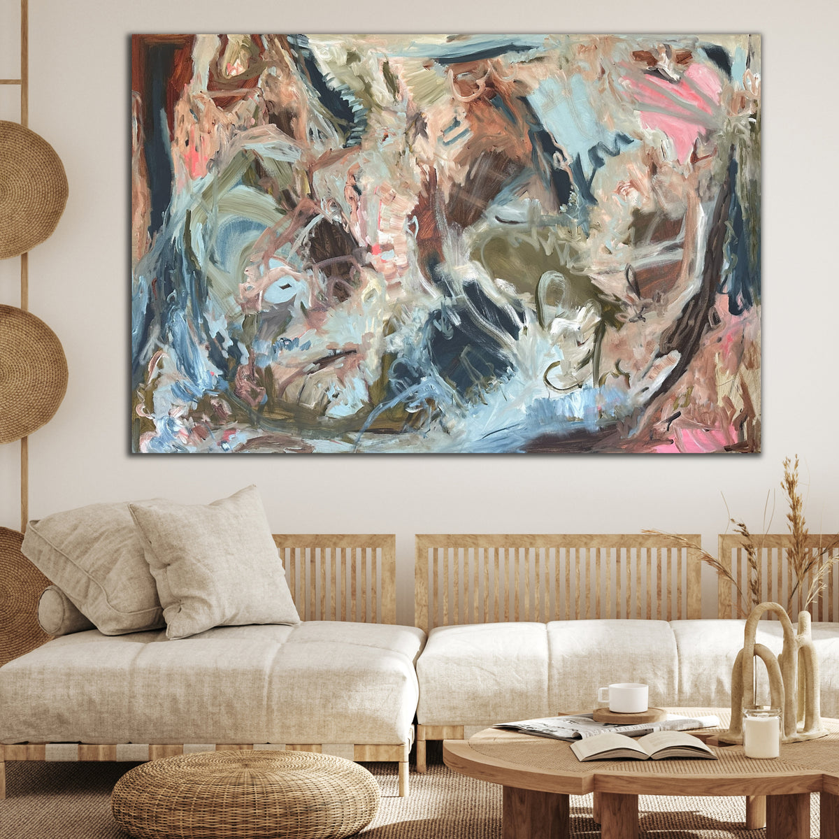 A large gestural abstract painting hanging above sofa in modern, neutral living room with earthy feel and natural timber furnishings.