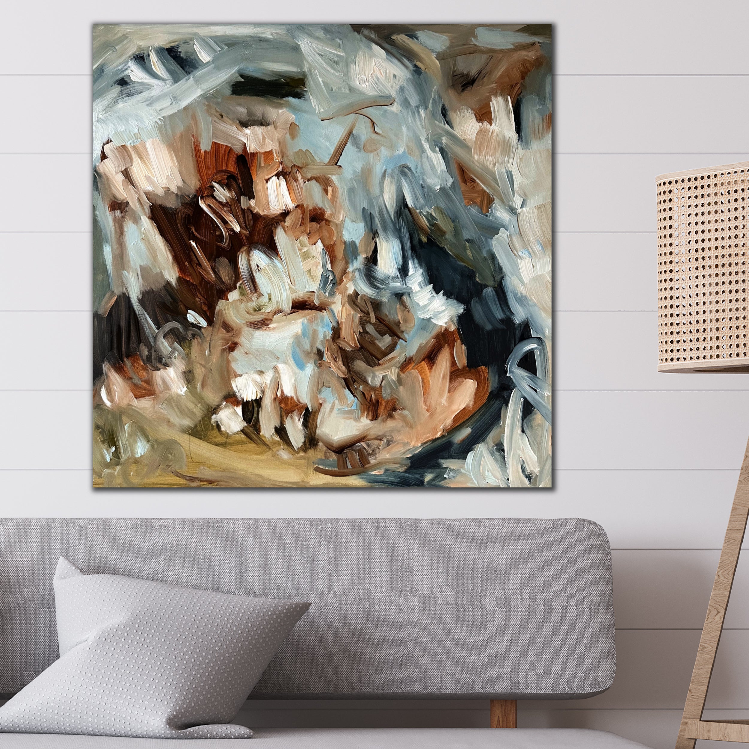 Expressive abstract painting in earthy colours on a wall in modern living room