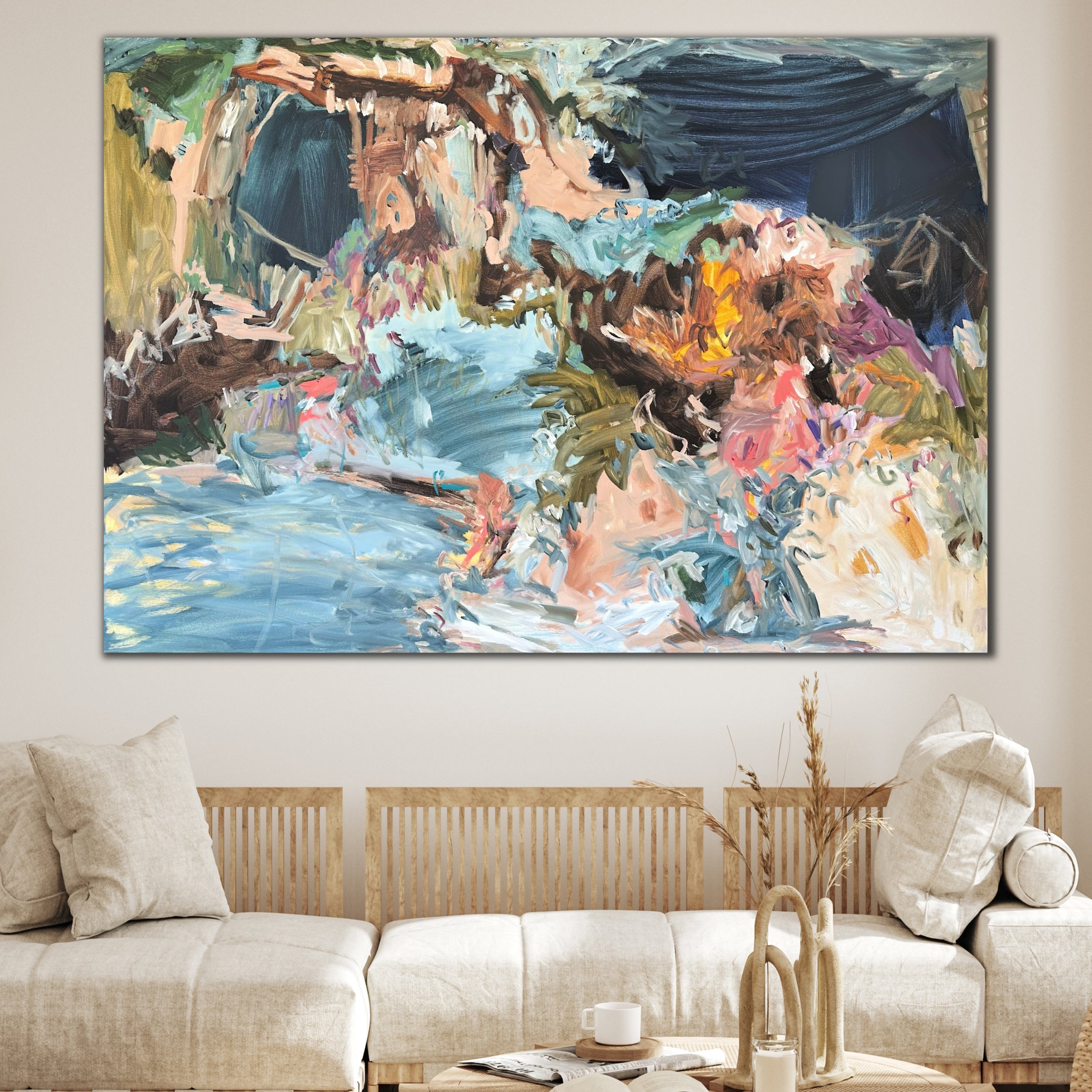Abstract painting on a wall above a sofa in a living room with neutral, natural furnishings