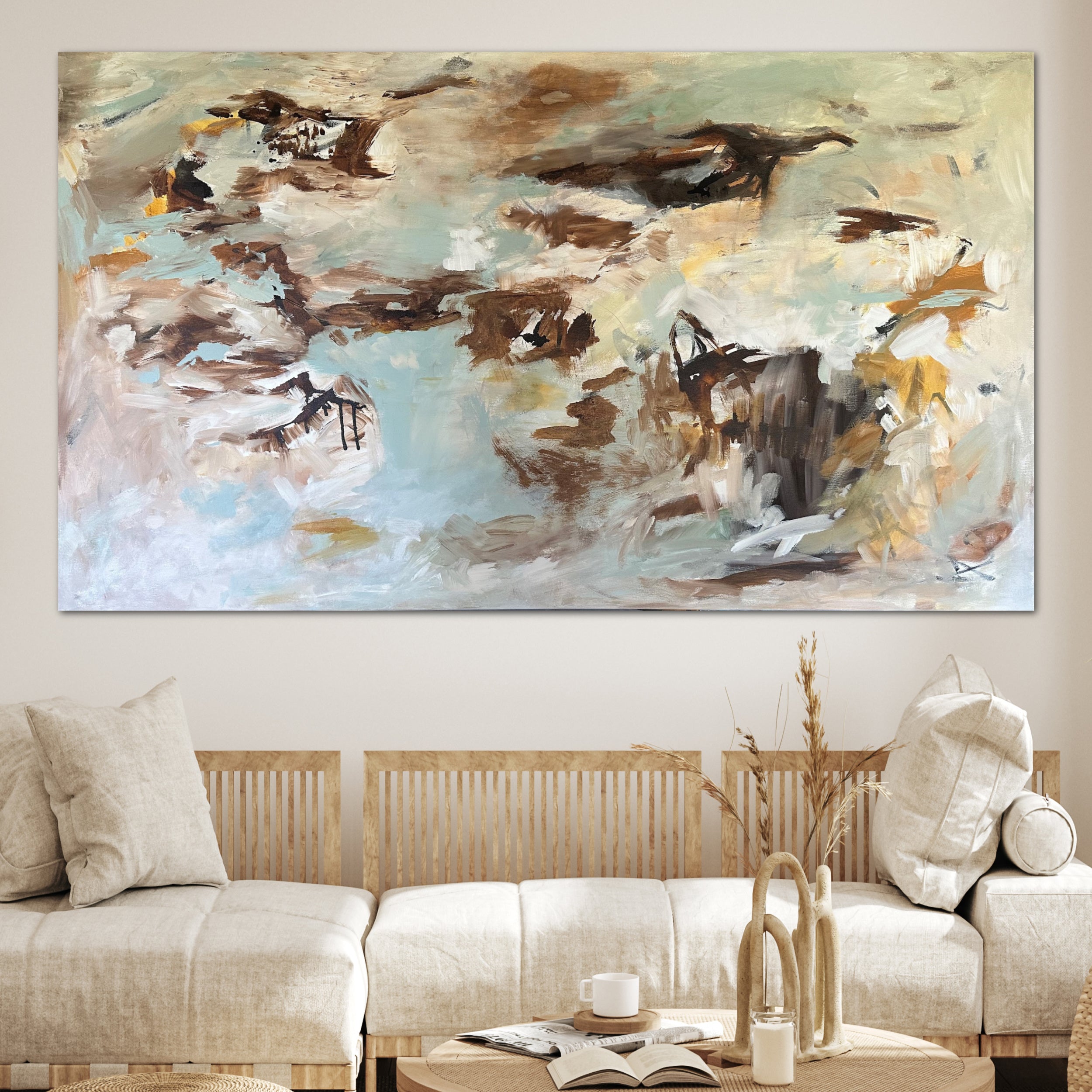 Calming abstract painting with expressive brushwork and mark-making hanging on wall over sofa in modern home with natural decor