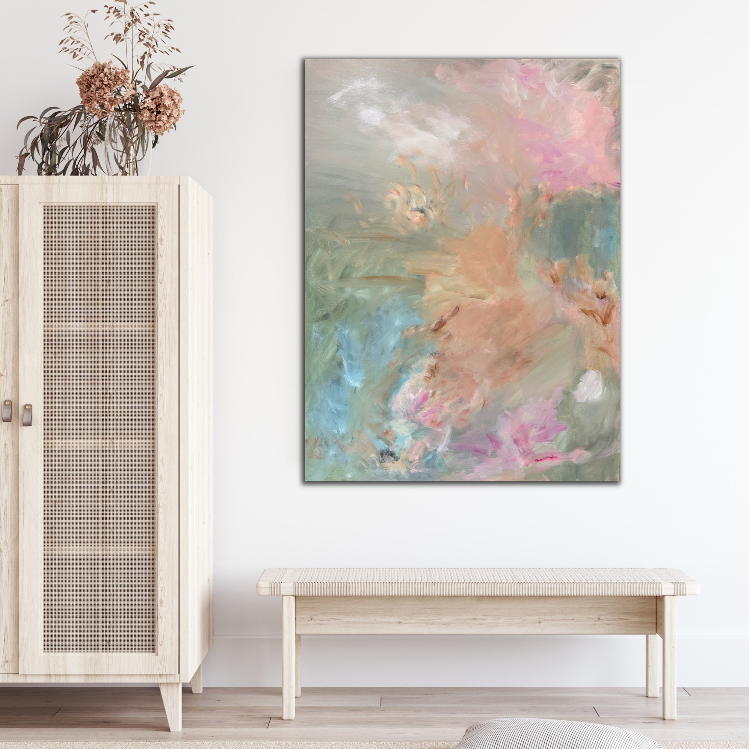 Contemporary abstract painting in pastel tones hanging on wall in modern home with natural decor
