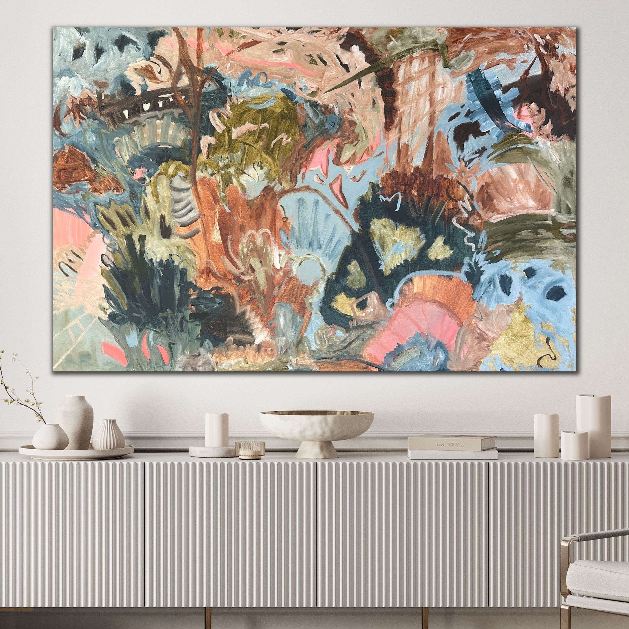 Large abstract wall art hanging in modern white interior space