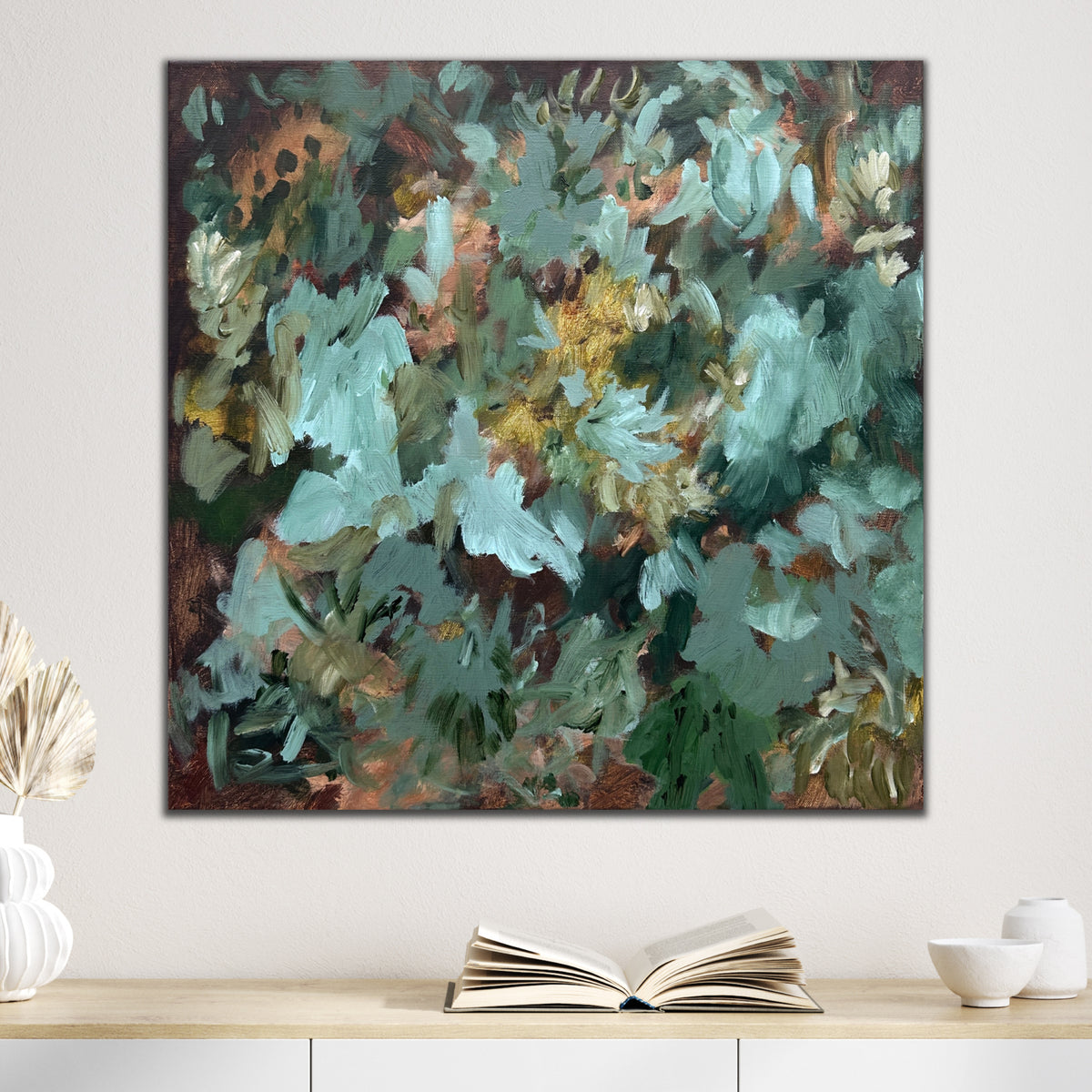 Abstract floral painting on canvas with subtle reference to plants and greenery hanging on wall in neutral interior with natural finishes.