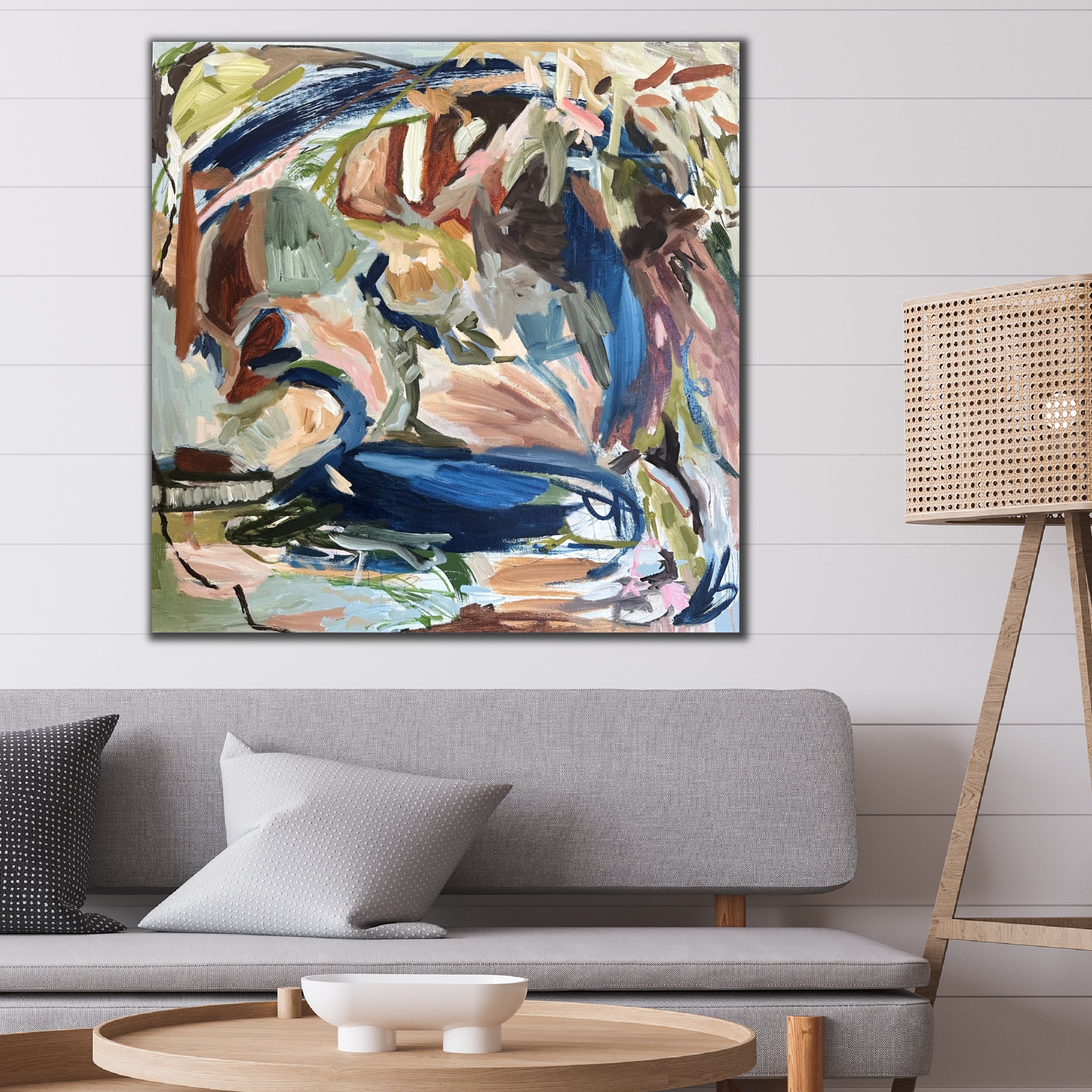 Square abstract wall art inspired by plants and nature hanging on wall in modern living room