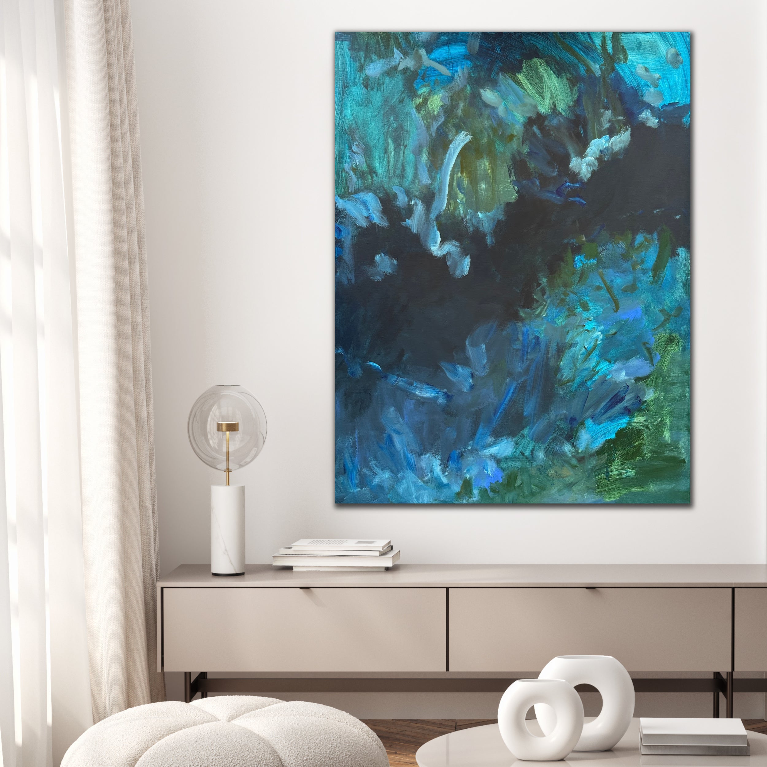 Modern abstract painting in blue an green that evokes emotion and movement hanging on wall in contemporary home interior