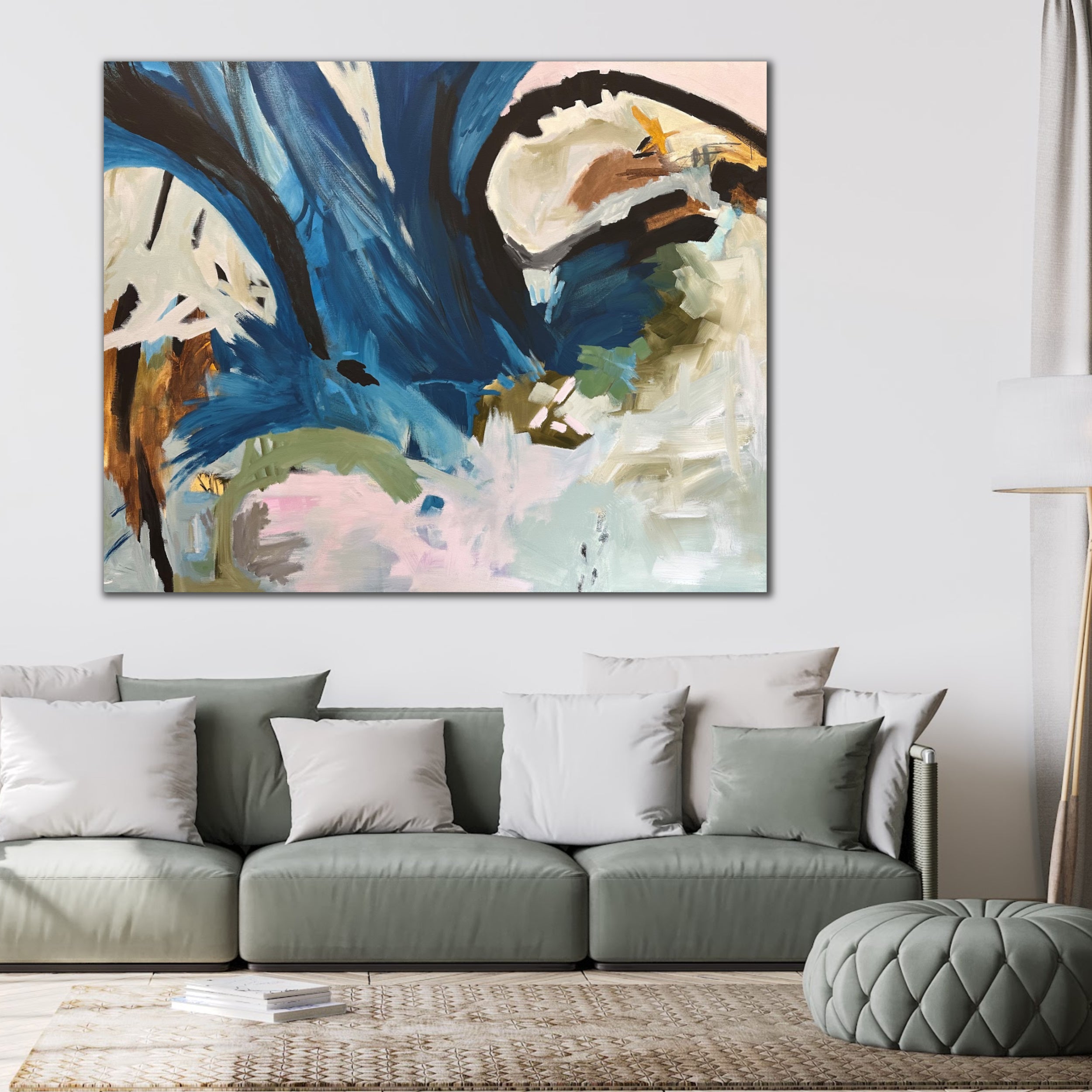 Contemporary abstract painting in blue, black, and neutral tones hanging on wall in modern living room