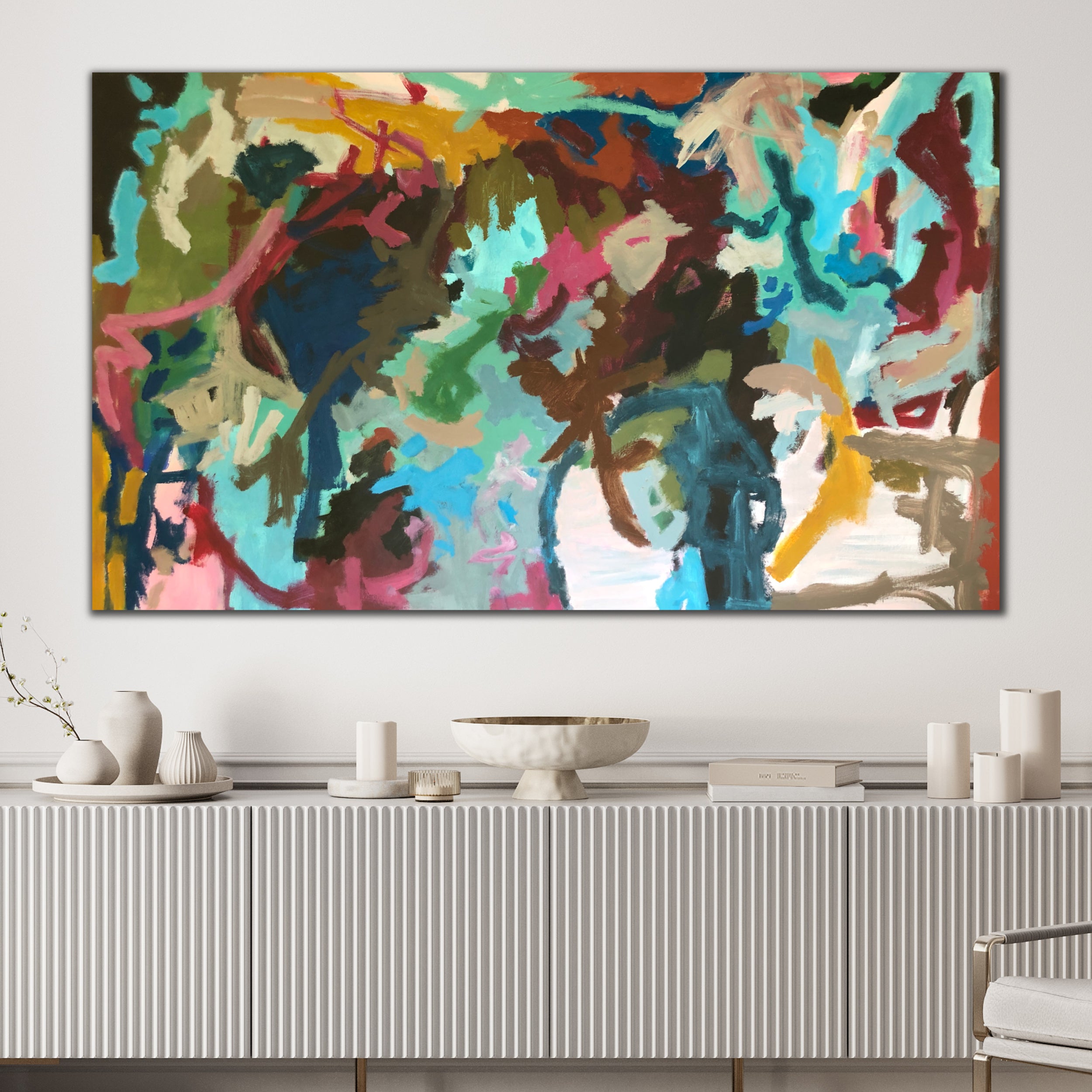 Large, multi-colour abstract expressionist painting that speaks to freedom, and energy hanging on wall in white, contemporary interior space