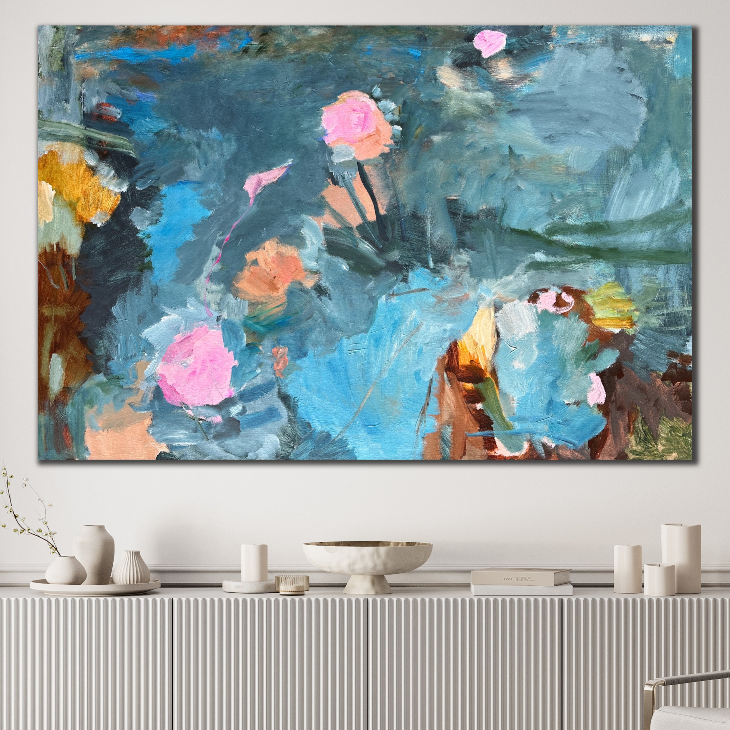 Large abstract painting in blue, pink, apricot, brown and green with floral forms and expressions hanging on wall in modern interior space