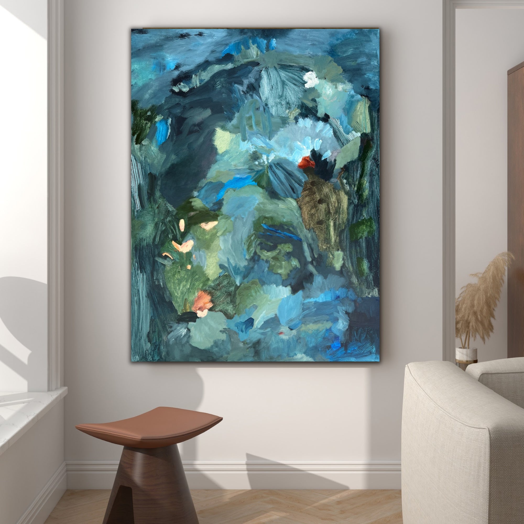 A calming abstract painting in soft blues and earthy greens hanging on wall in modern living room