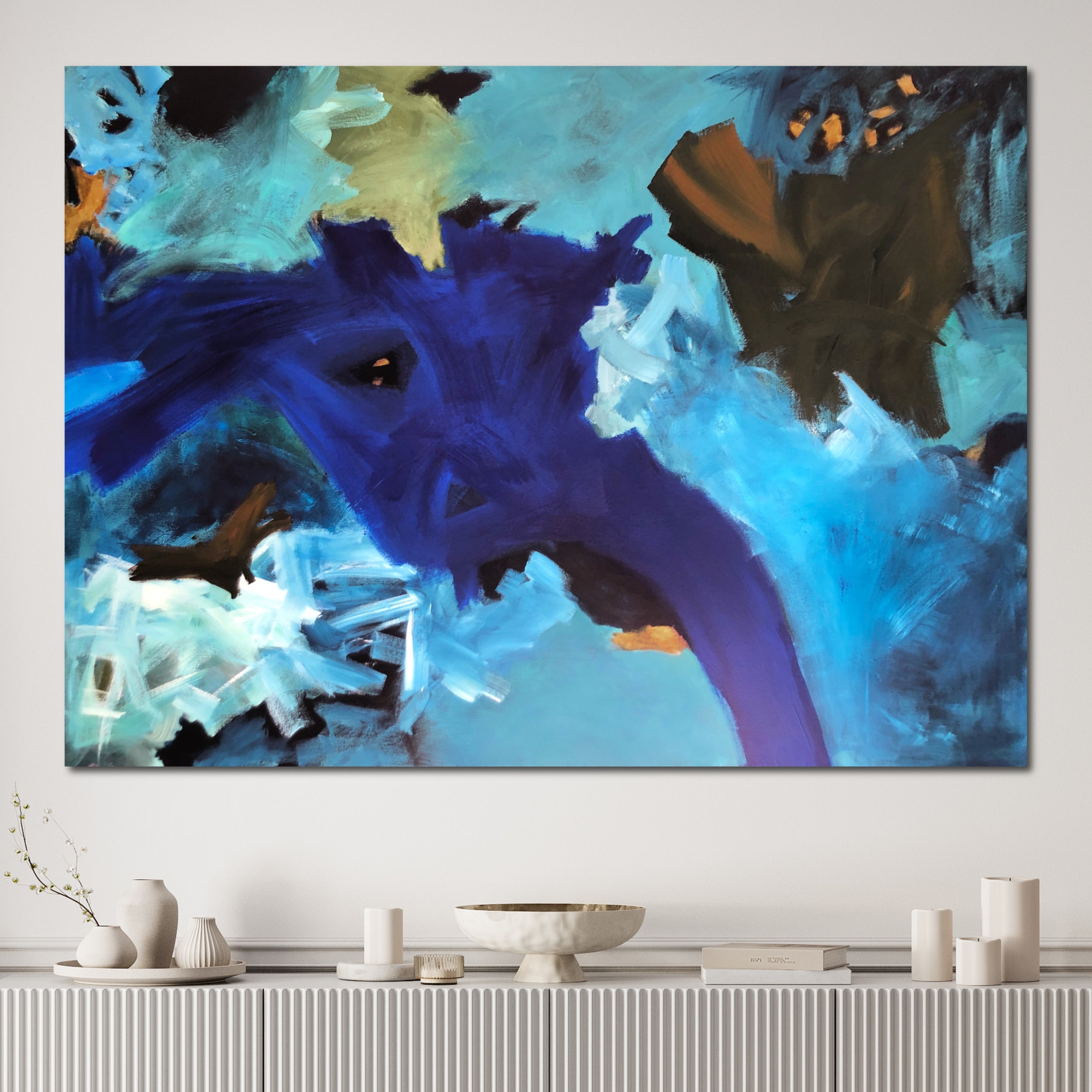 Large blue original abstract painting hanging on wall in white, modern home interior