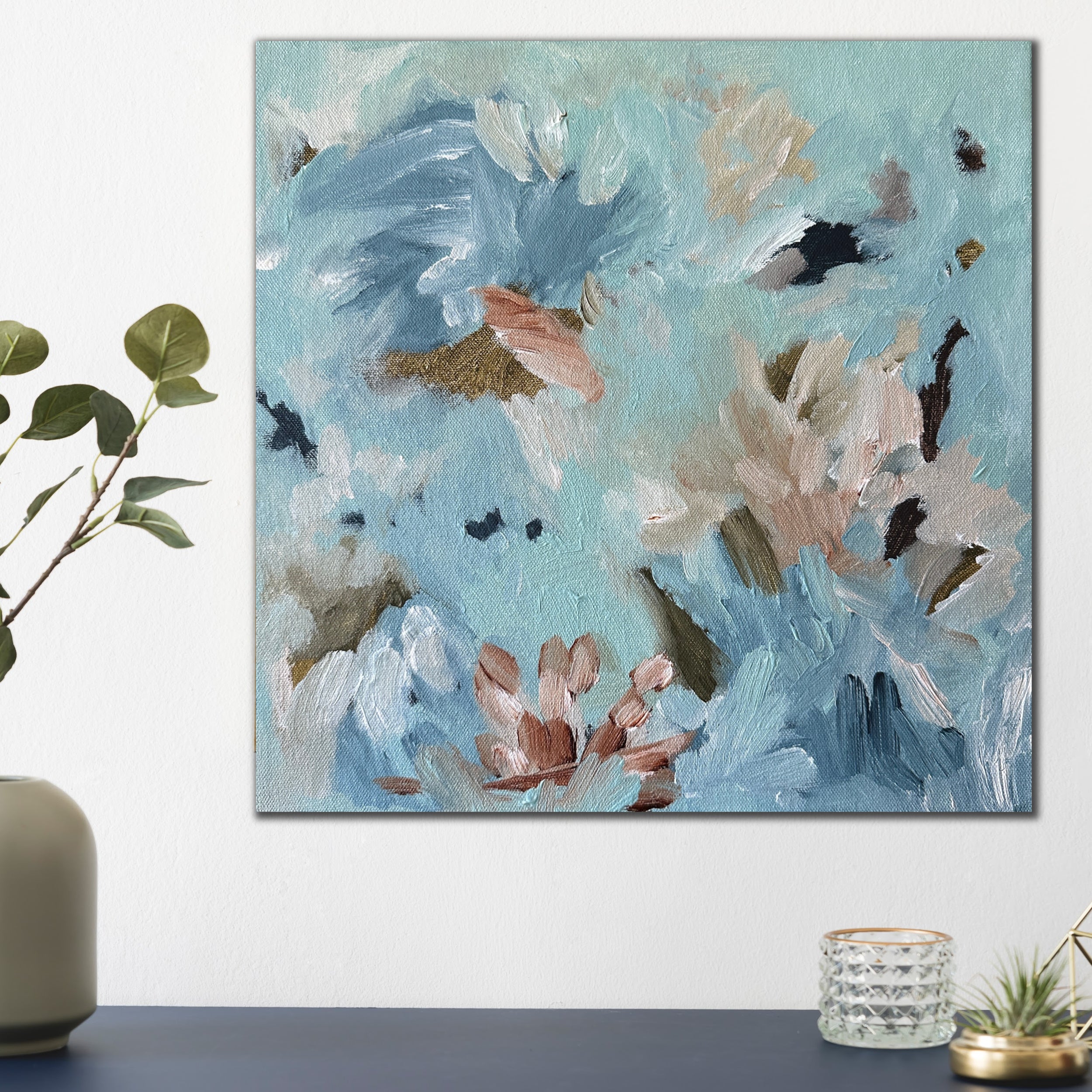 Small, square blue abstract painting inspired by nature and flowers on canvas hanging in modern home