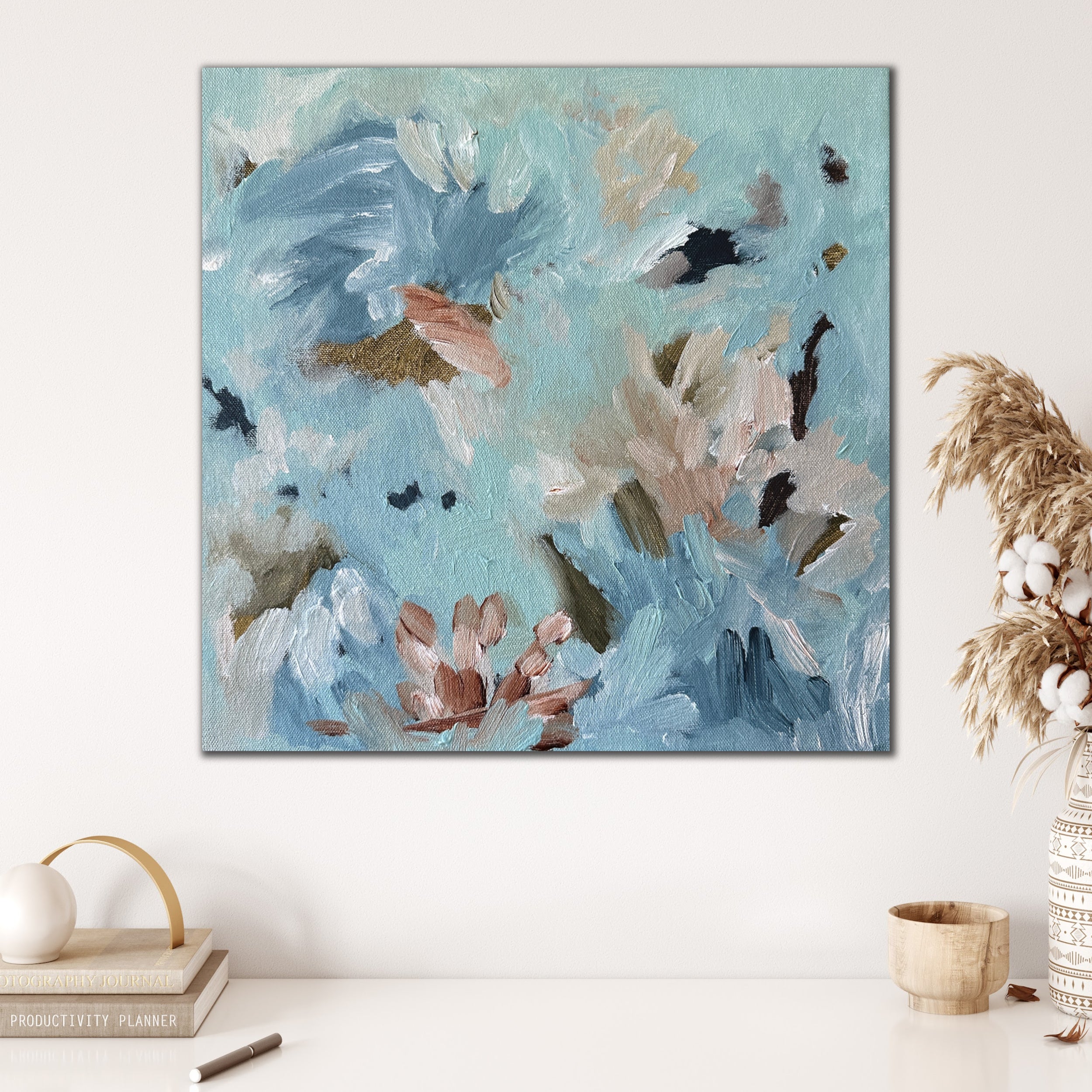 Soothing abstract painting in soft blue and neutral tones hanging in modern neutral interior with nature inspired décor