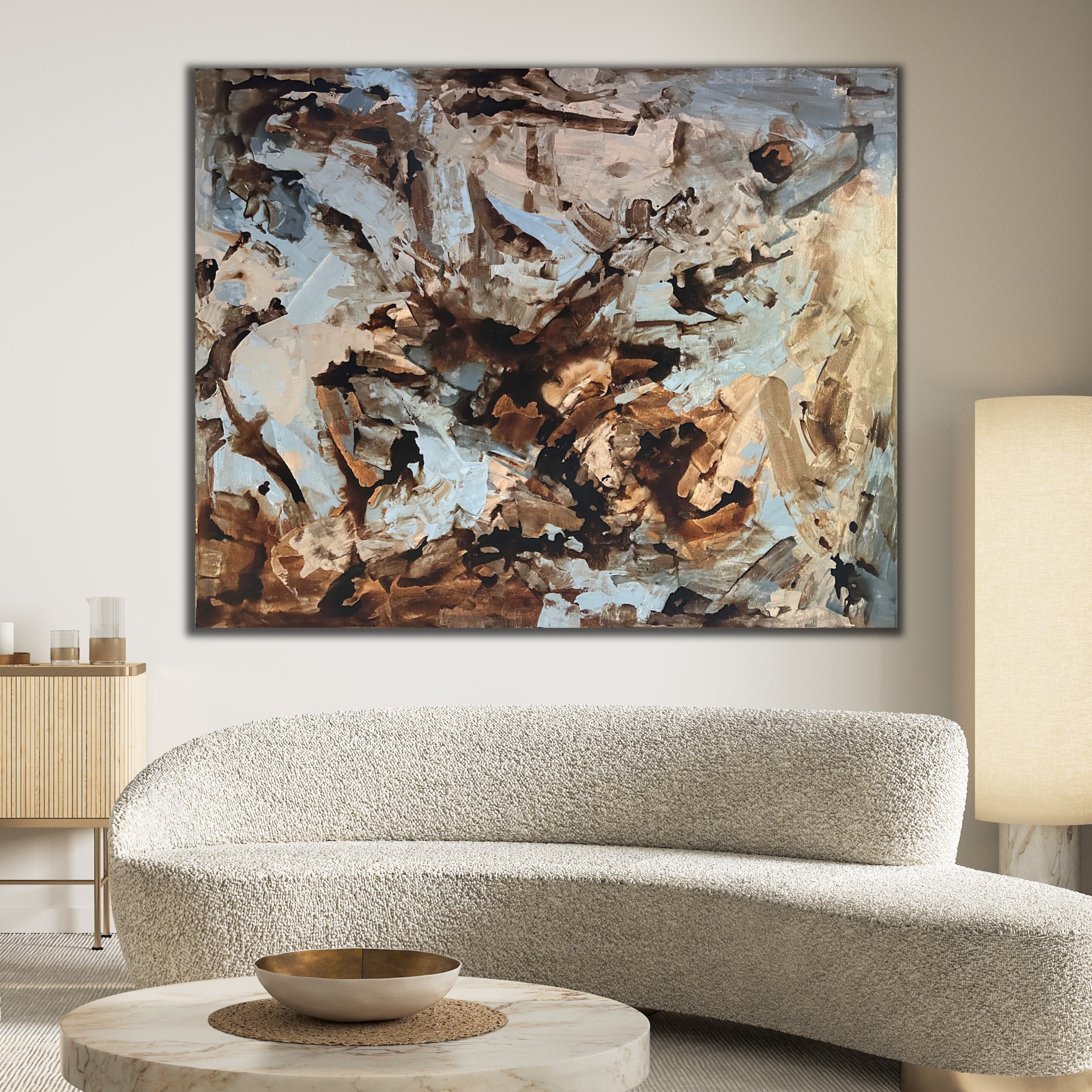 Large neutral abstract artwork hanging in luxury living room