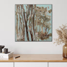 A small square painting of Australian gum trees hanging on wall in modern home with neutral furnishings. 