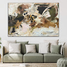 Contemporary abstract painting hanging above a sofa in a living room