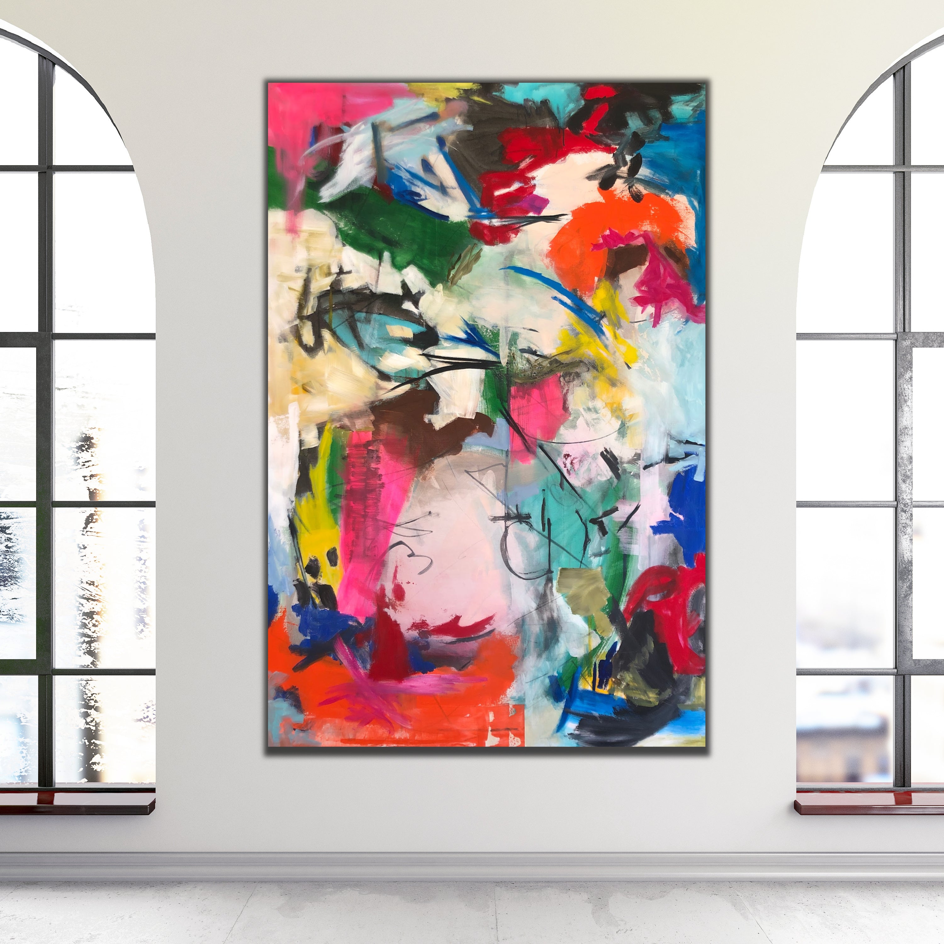 A large abstract canvas painting with vibrant splashes of pink, red, orange, green, blue, black, and white, displayed on a neutral coloured wall between two tall arched windows.