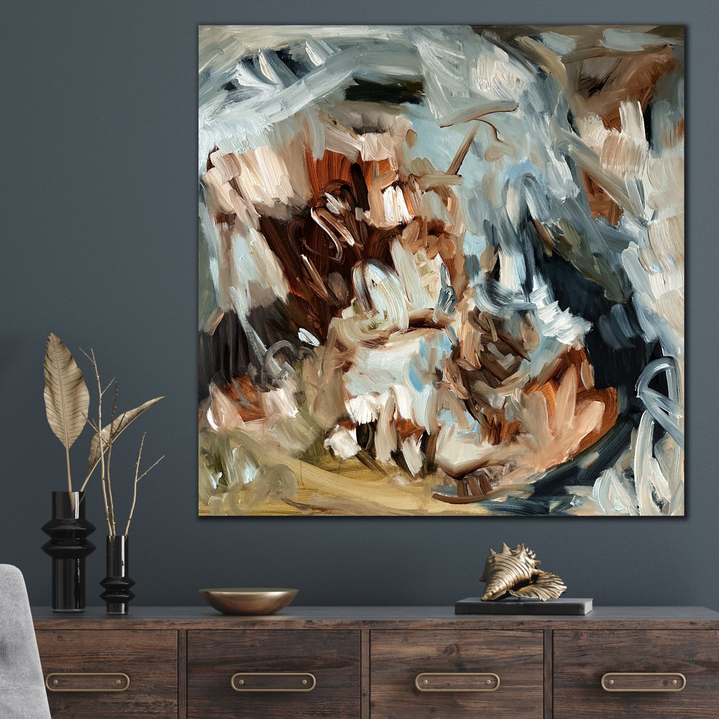 Abstract expressionist painting hanging on a dark wall above a wooden console