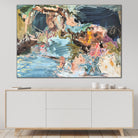 Abstract painting on a wall above a cabinet in a neutral home interior