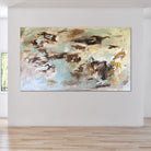 Oversized abstract expressionist painting in light blue, brown, white and beige hanging on wall in modern home 