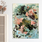 Abstract floral painting in gestural style with terracotta brown, green and light blue tones hanging on wall in room with natural furnishings