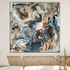 Square abstract painting inspired by nature in blue, brown, beige, white and olive green in neutral interior with natural furnishings