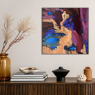 Small abstract painting hanging in contemporary home with neutral furnishings. 