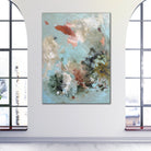Modern abstract painting alluding to water or air in nature hanging on wall in light filled room