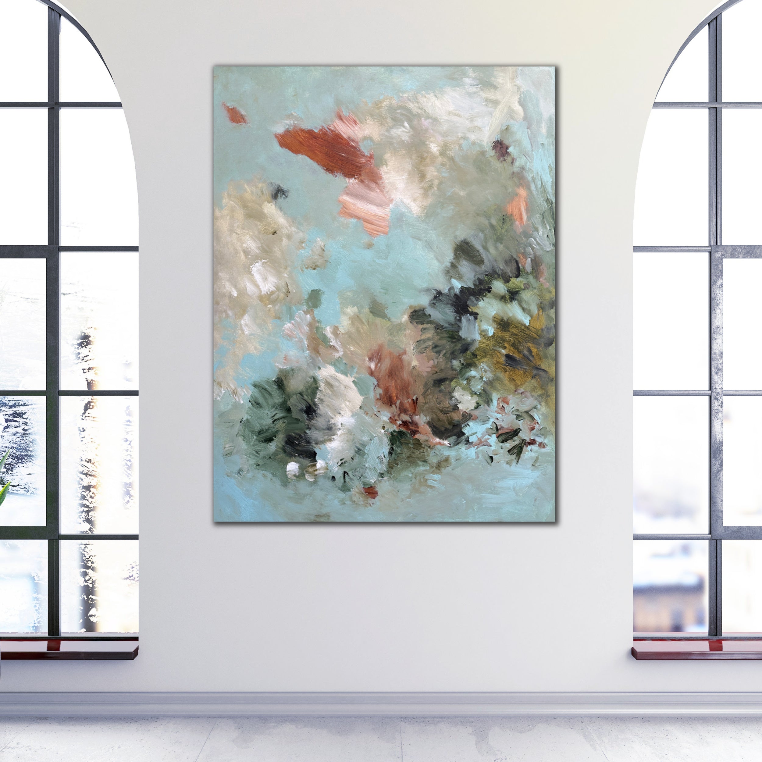 Modern abstract painting alluding to water or air in nature hanging on wall in light filled room