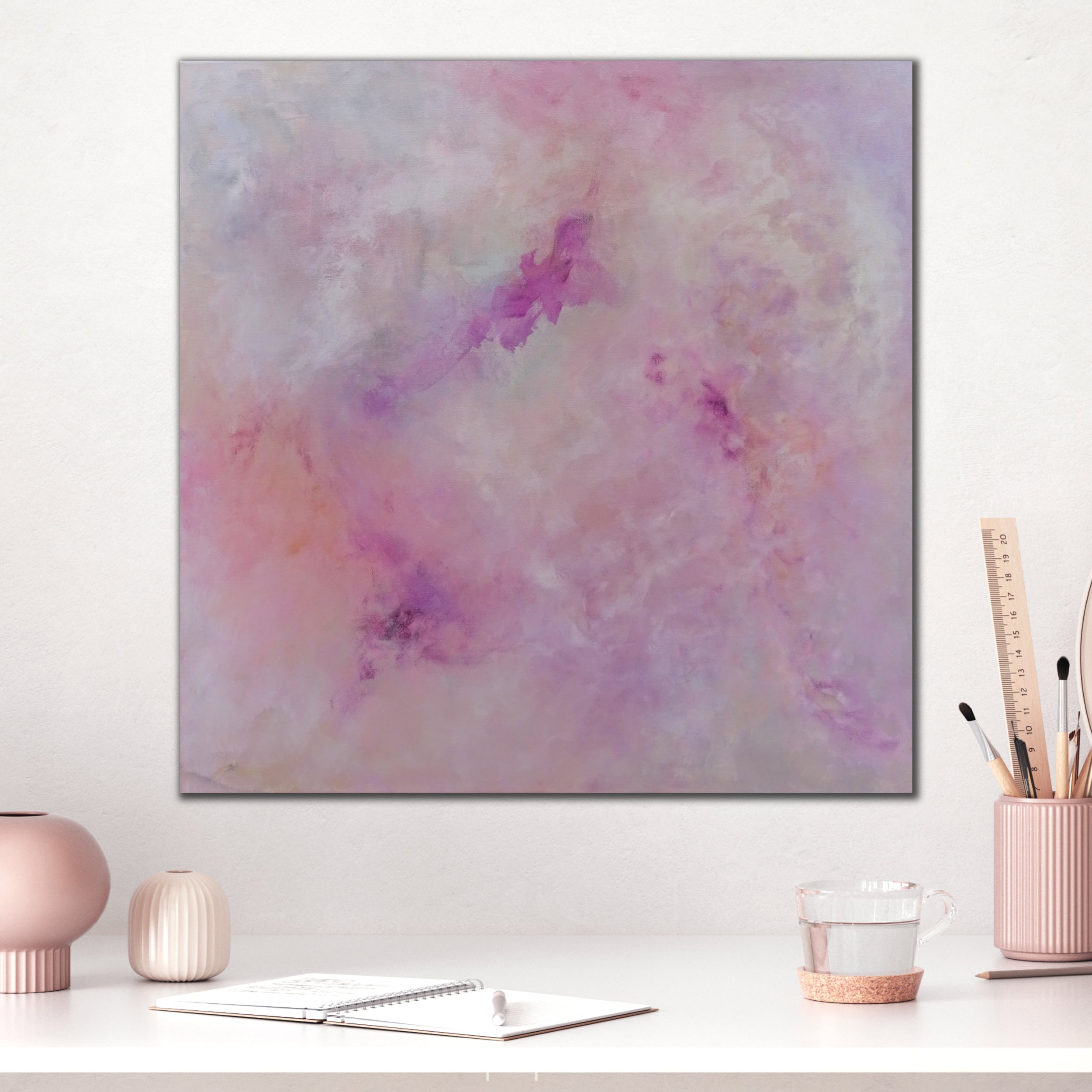 Square, pink abstract painting hanging on wall above desk in modern home office interior - insitu