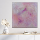 Pretty, modern abstract painting in shades of pink that feels mystical and magical hanging above cupboard in modern neutral interior space - in situ