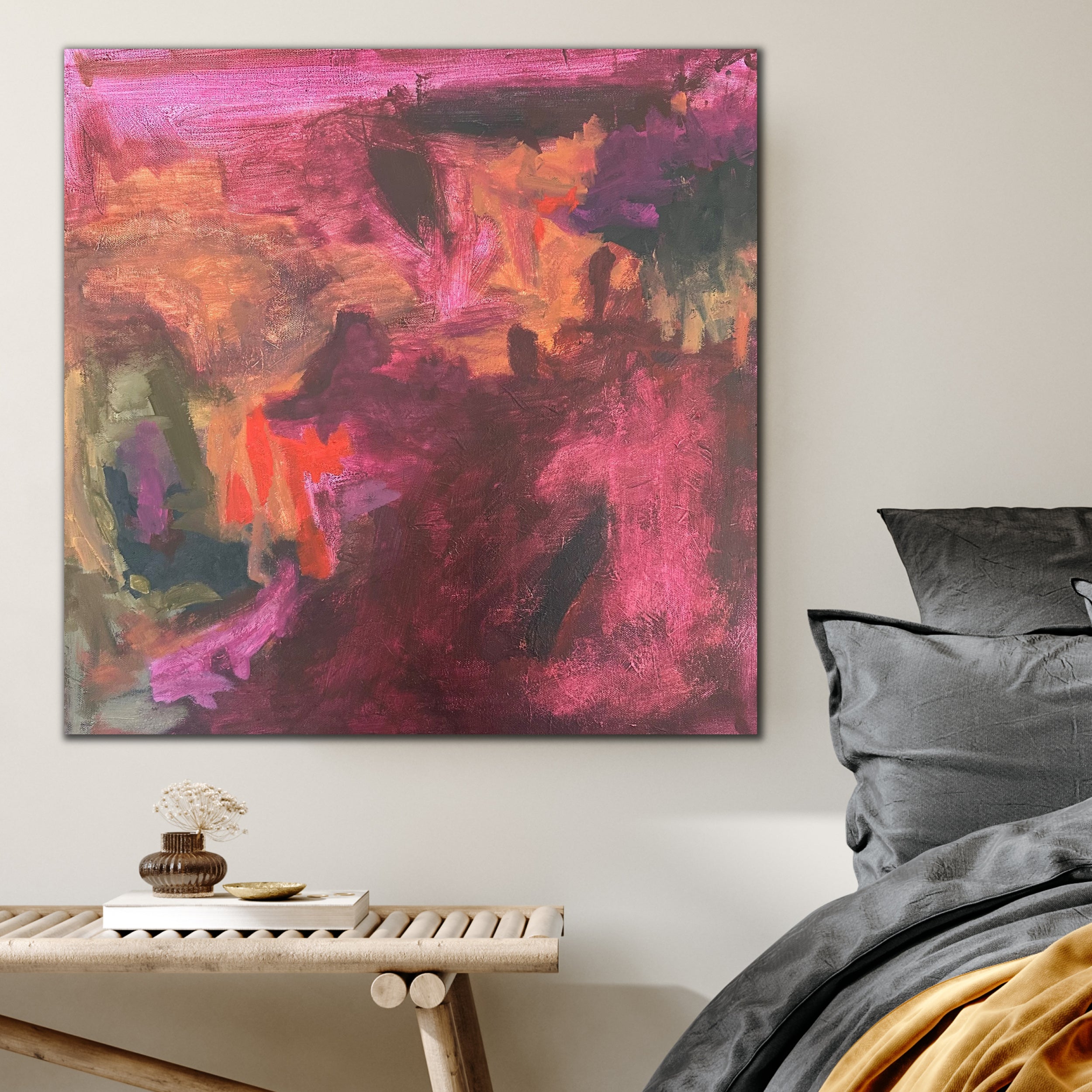 Expressive abstract painting in burgundy, pink, orange and green hanging in bedroom of home interior