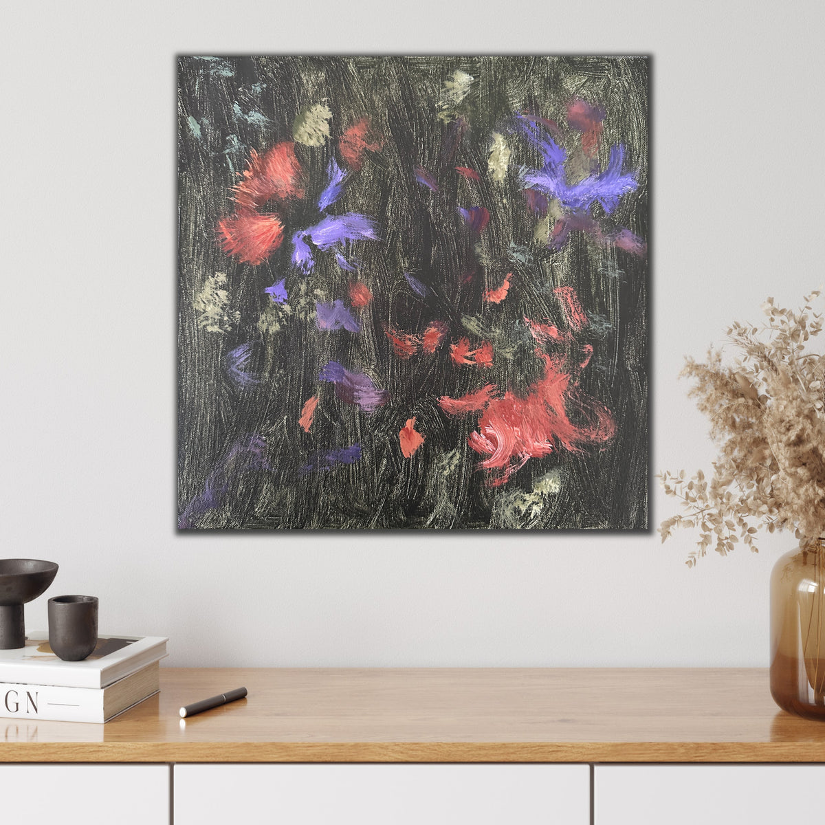 Expressive abstract painting in shades of green, burnt orange, purple and black hanging on wall in modern interior with natural, neutral furnishings and decorative accessories.