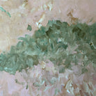 Close up detail of abstract artwork in green, beige, pink and soft, warm tones