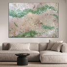 Large abstract painting with calming feel hanging in modern living room with neutral colour palette