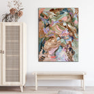 Expressive abstract landscape painting of nature and plants hanging on wall in entry way of home  with natural furniture and fittings