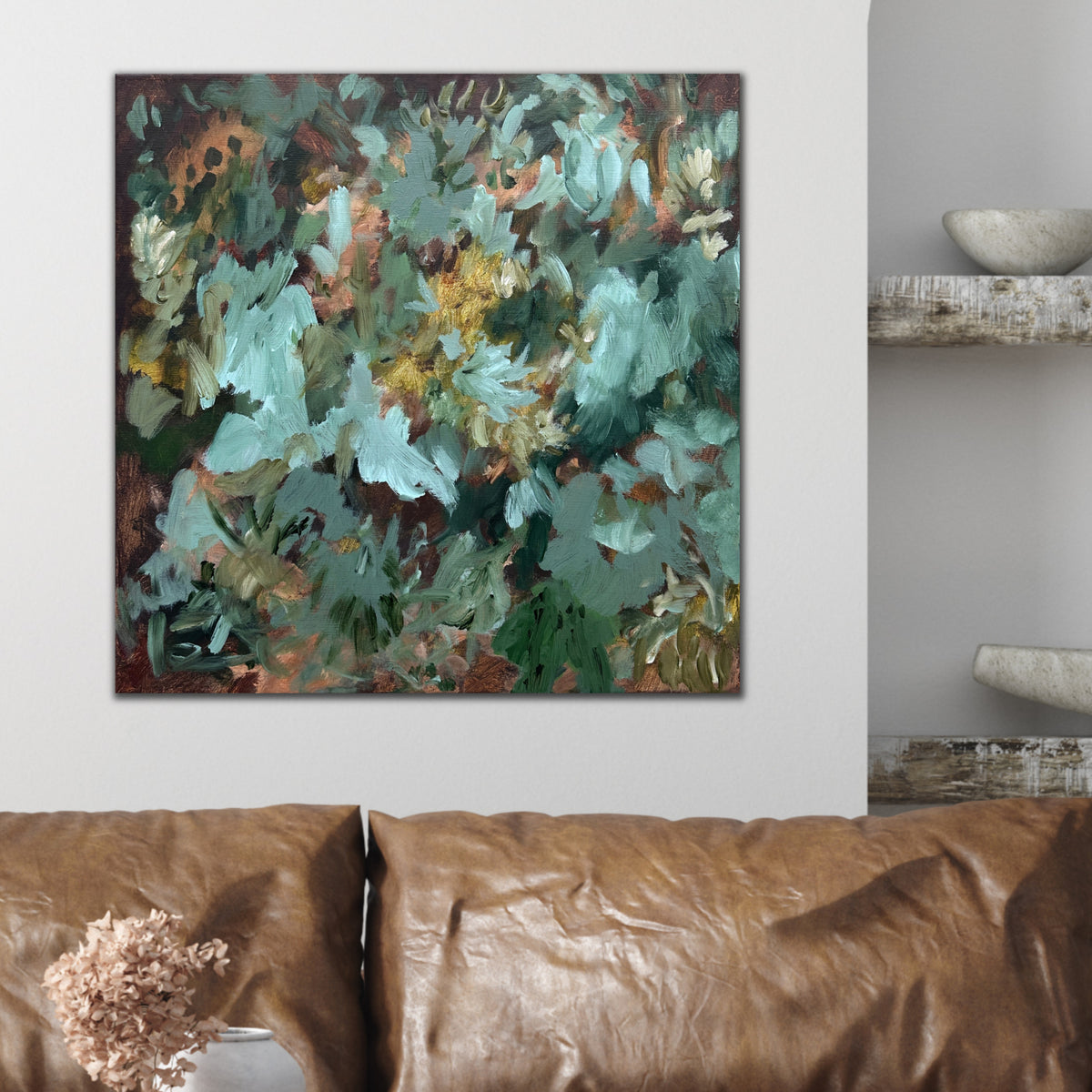 Contemporary abstract wall art in brown. shades of green (forest, sage, emerald, olive) and light blue hanging above sofa in modern interior space with neutral furnishings and natural wood accessories.  