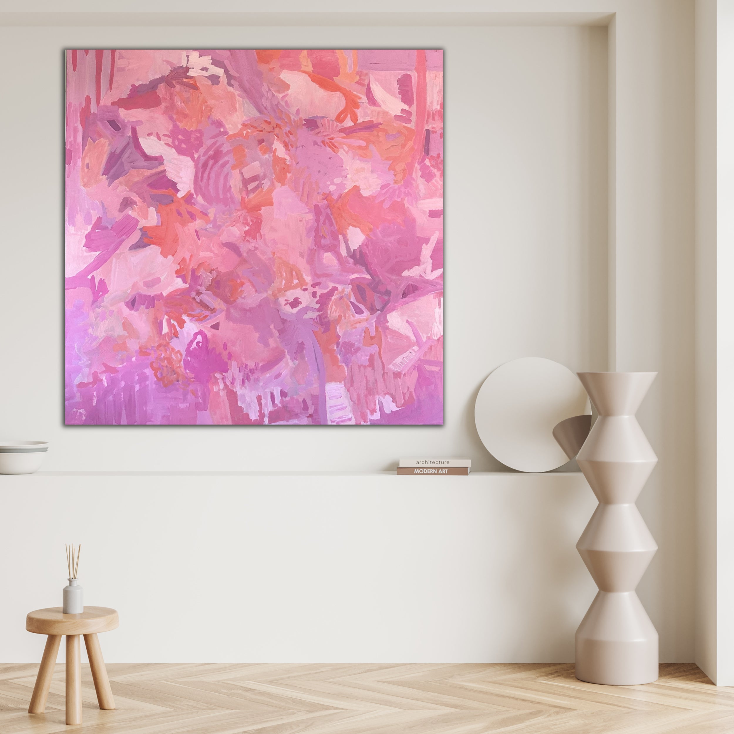Modern abstract painting 'Happy Land" in pink and purple tones hanging in a neutral, modern interior space