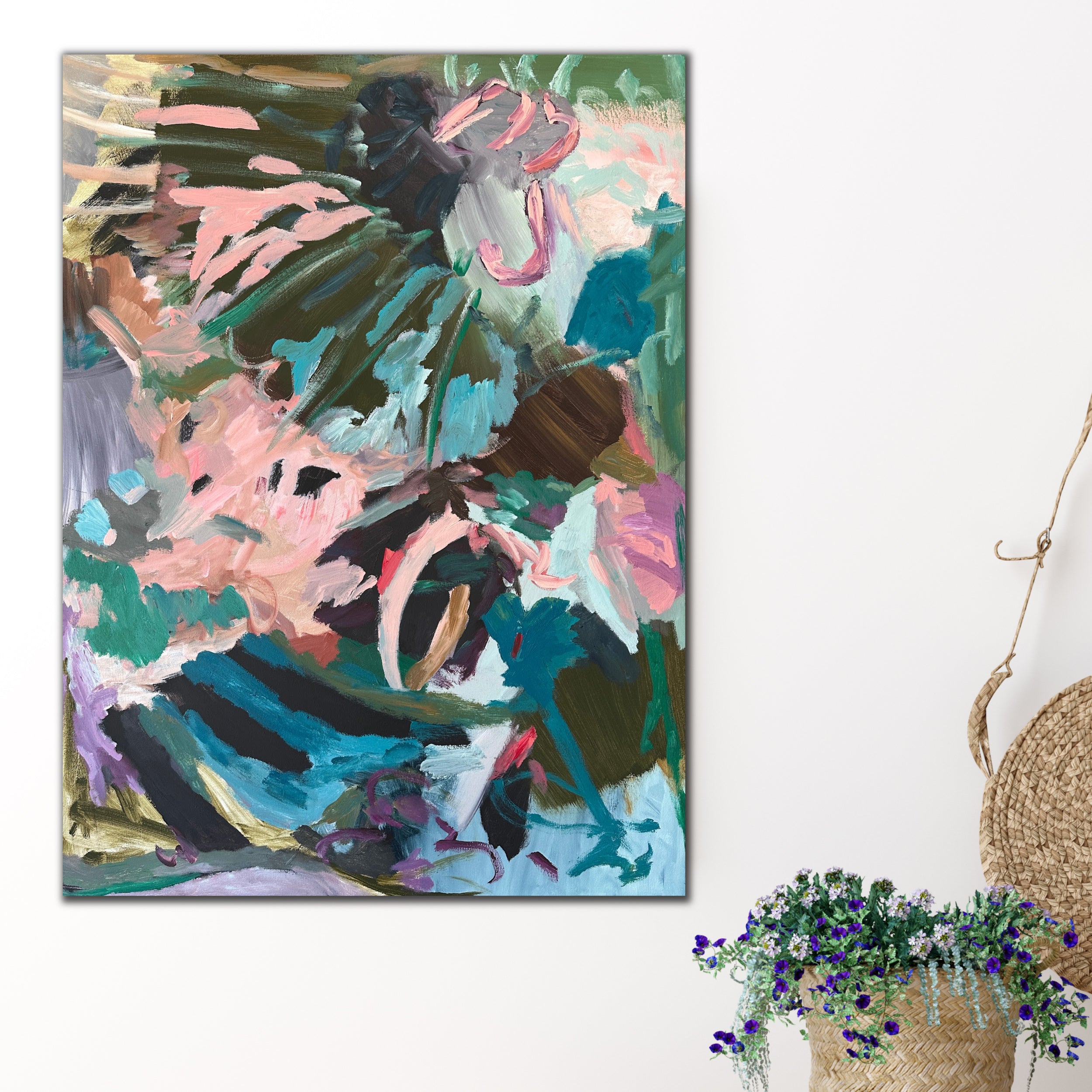 Colourful garden inspired abstract painting hanging on wall in neutral modern interior with plant basket