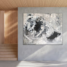 Black and white abstract painting "Power Play" hanging on wall in minimalist, neutral modern home interior 