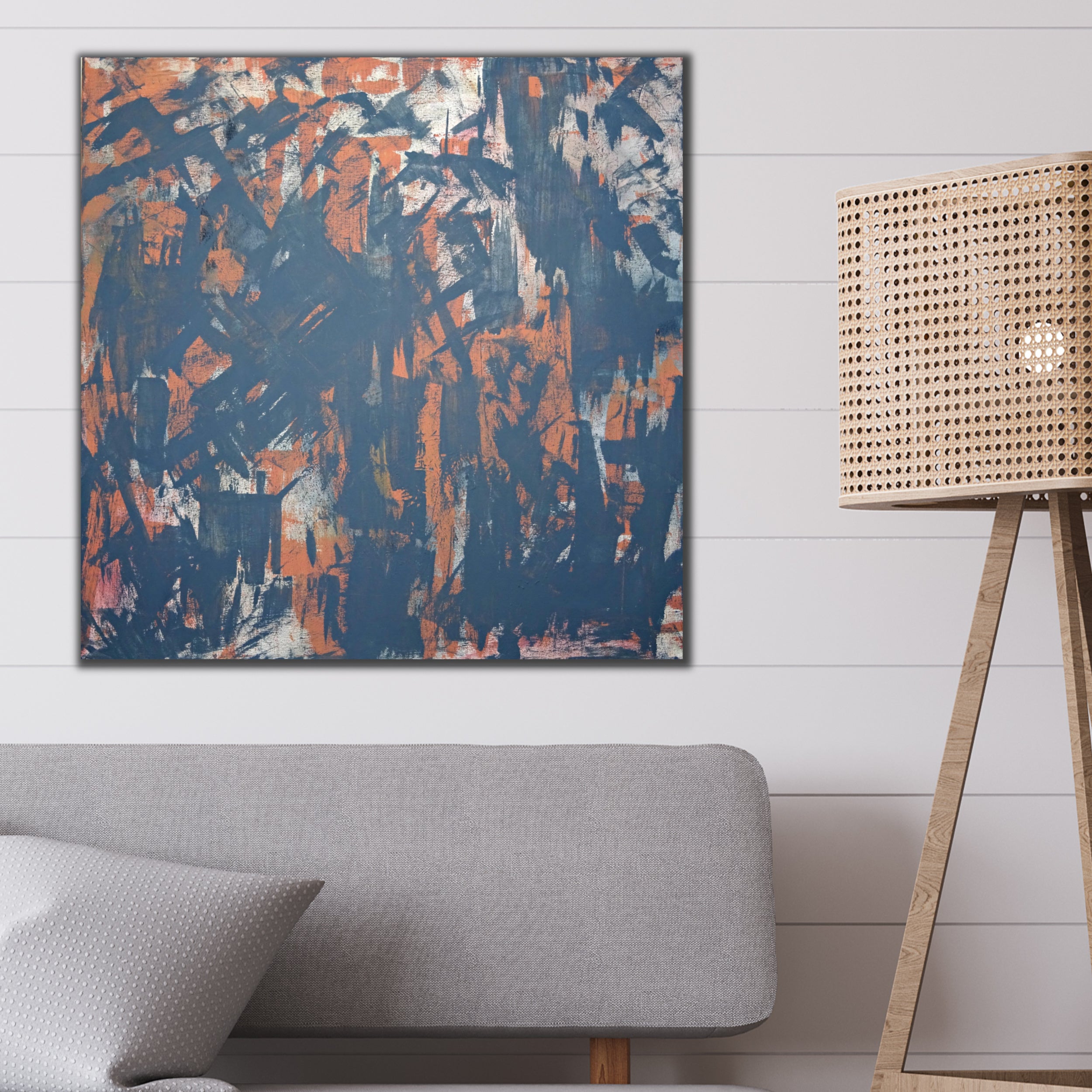 Square, contemporary abstract painting in black and red hanging on wall above lounge in a modern interior - home interior