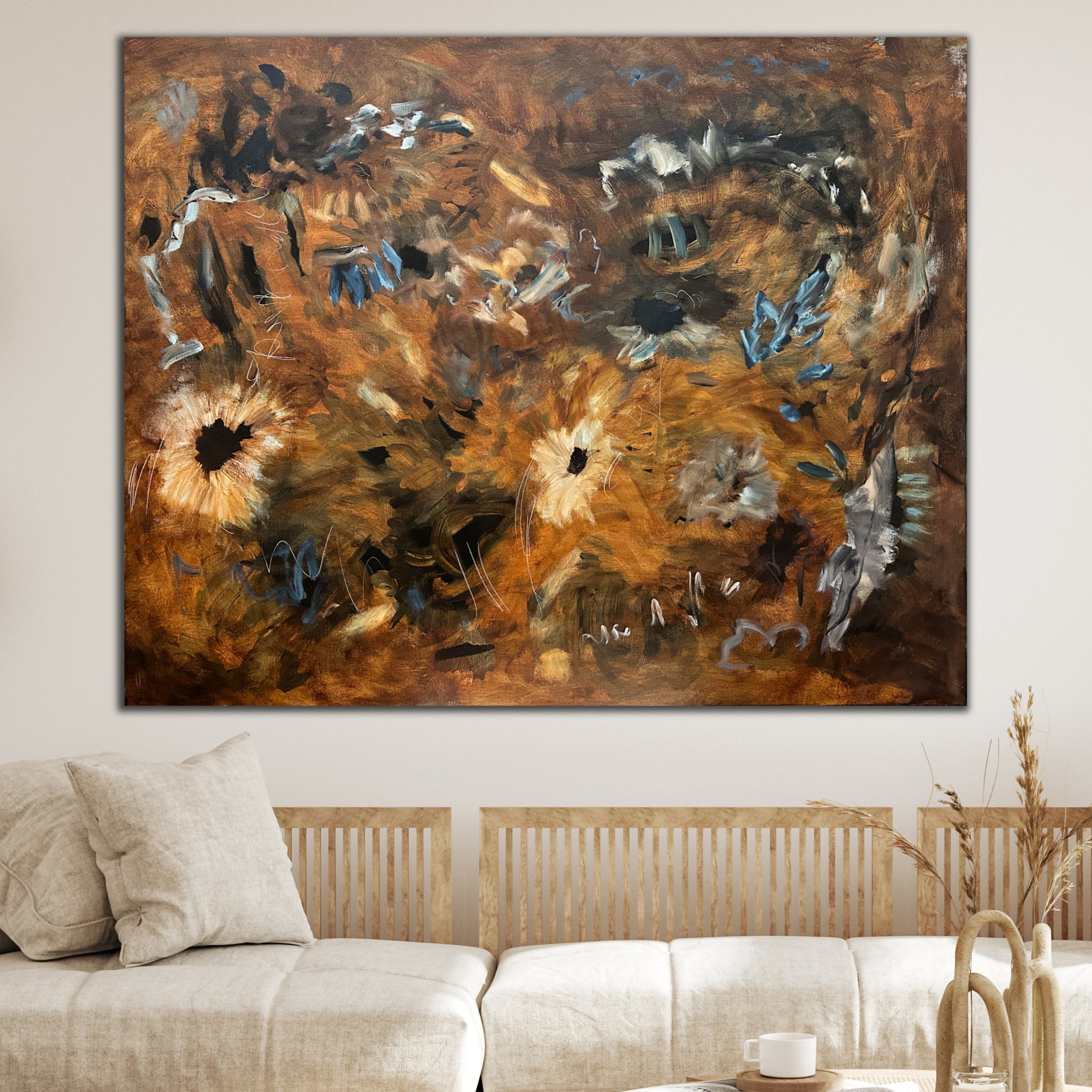 Large abstract painting on canvas hanging on a wall above a sofa in a living room