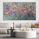 Large green abstract painting with purple, rust red and brown gestures hanging on wall in modern living room