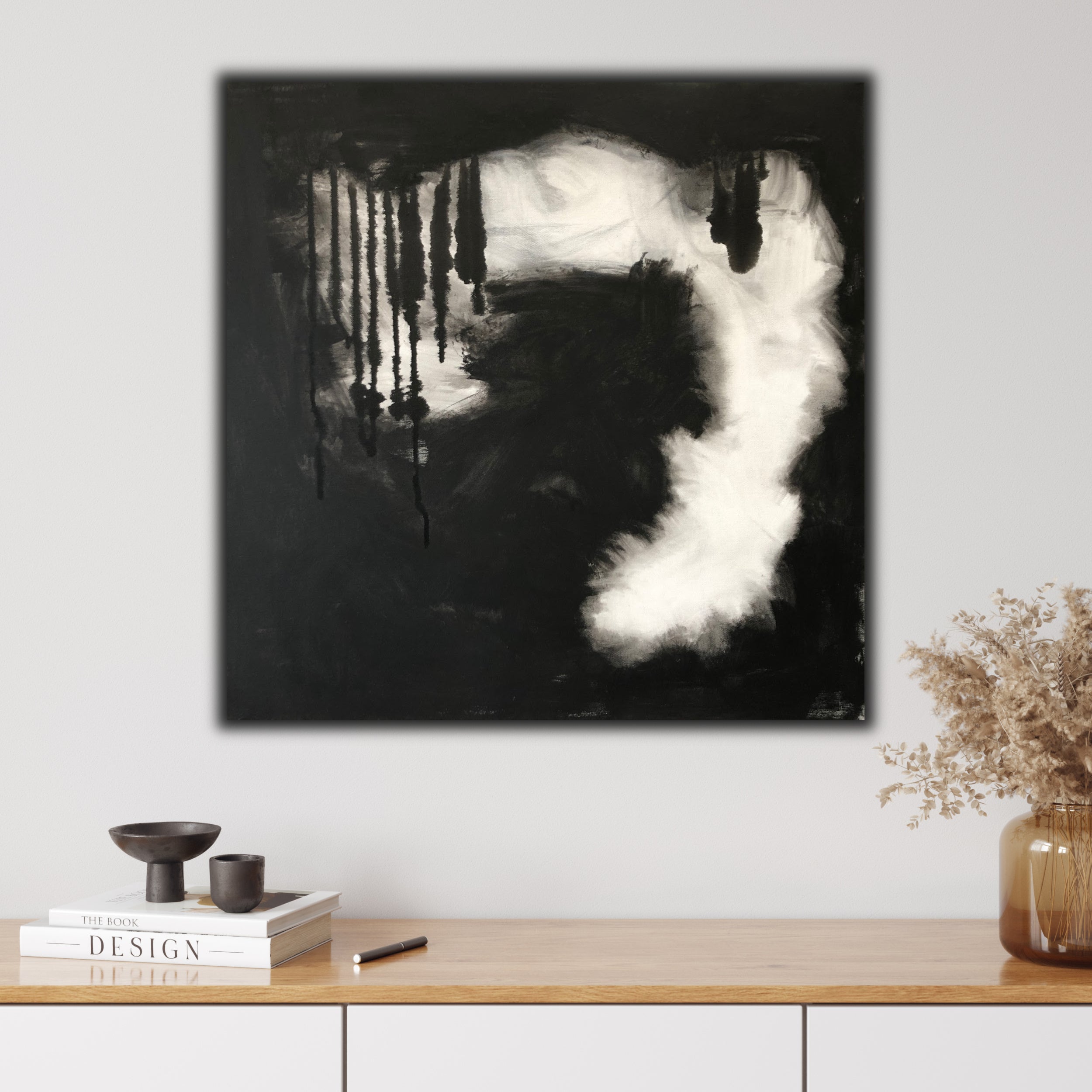 Contemporary abstract painting in black and white with expressive brushstrokes and plumes of smoke hanging on wall in modern home interior - in-situ