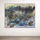 Abstract painting in natural earthy colours on a white wall