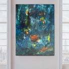 Contemporary abstract painting in shades of blue hanging in modern white interior. 