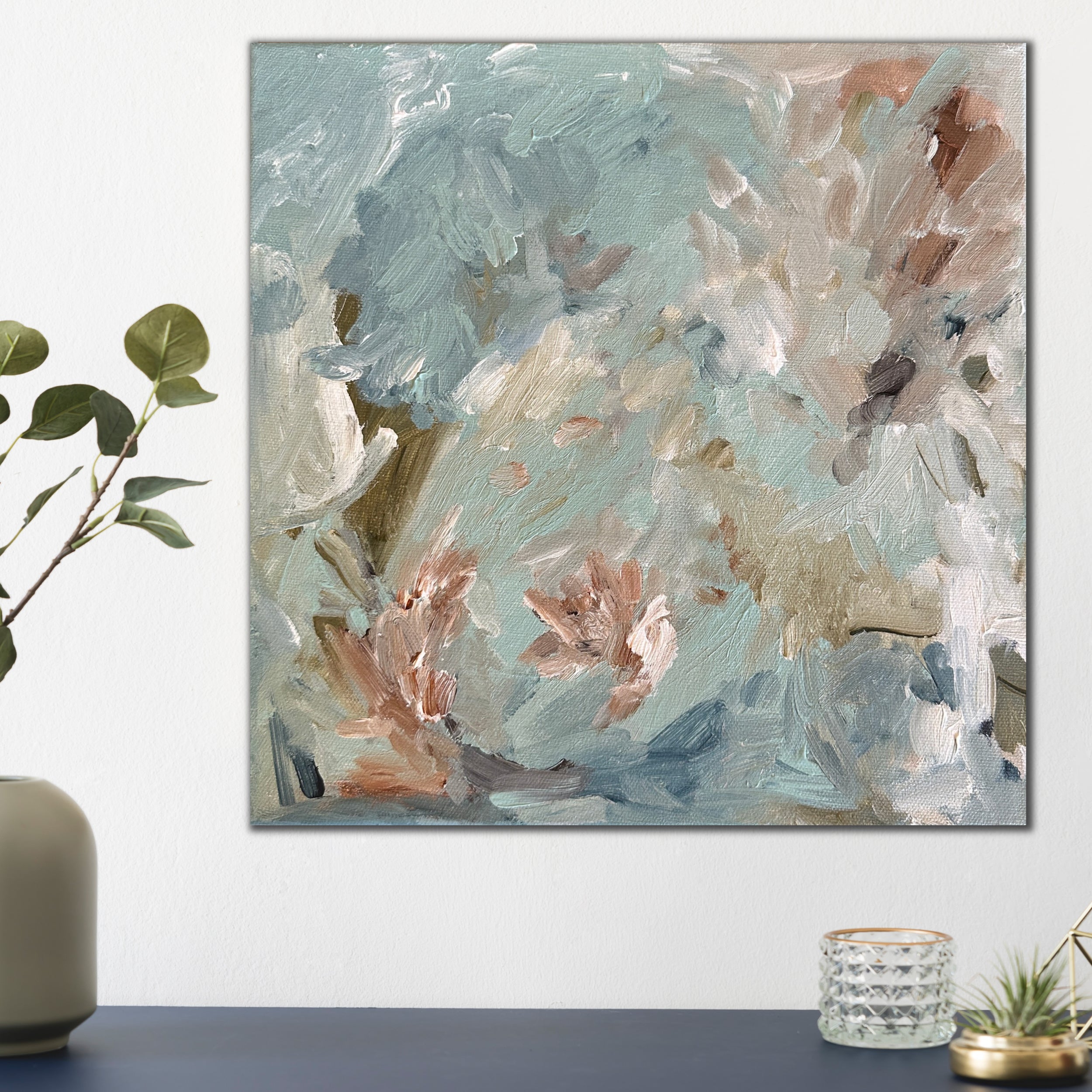Small, square blue abstract painting inspired by nature and flowers on canvas hanging in modern home