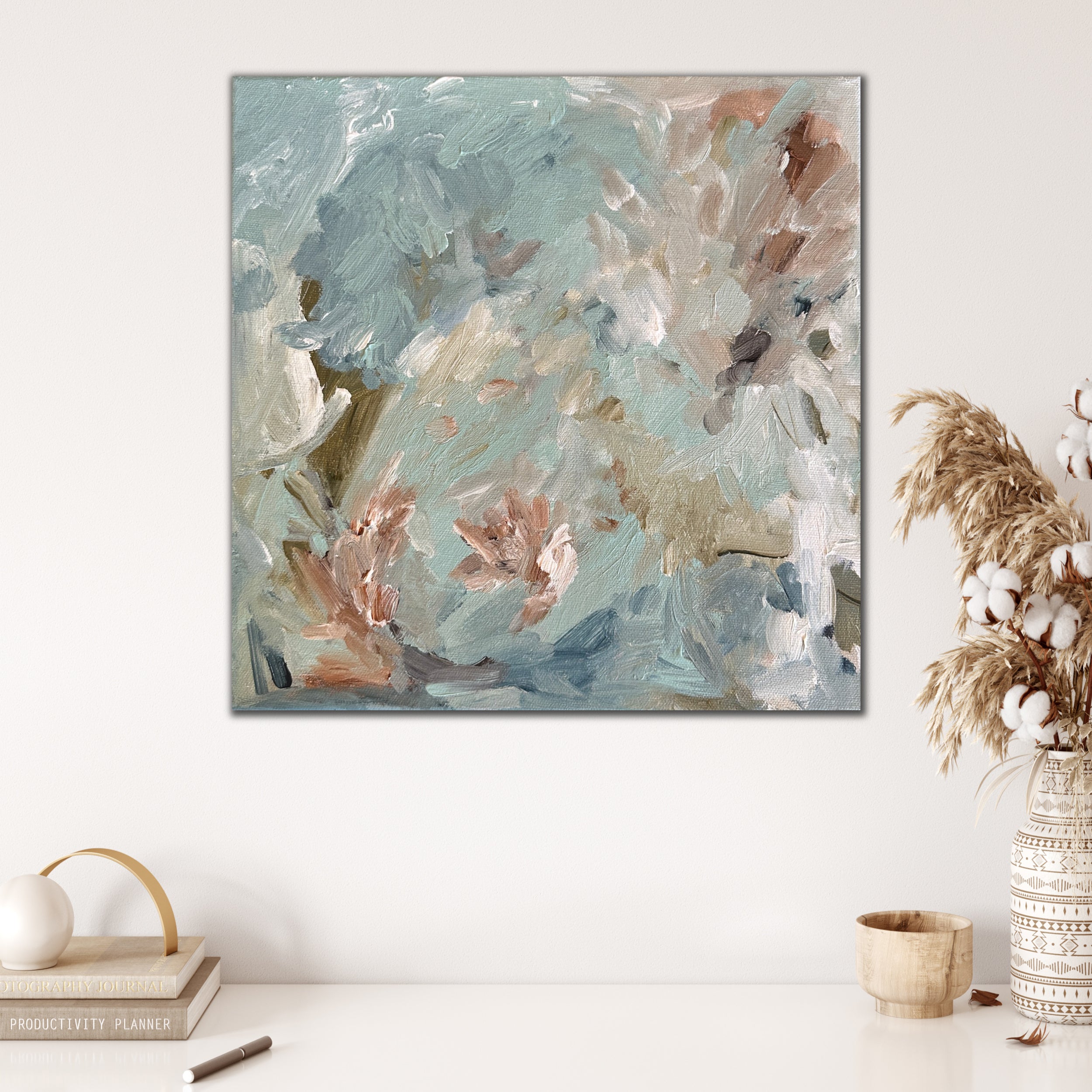 Soothing abstract painting in soft blue and neutral tones hanging in modern neutral interior with nature inspired decor